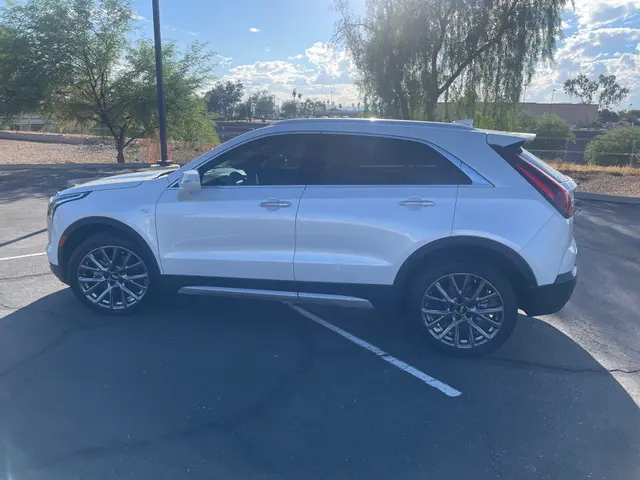 A white suv parked in a parking lot.